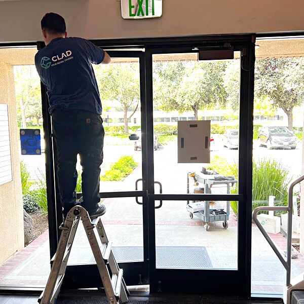 one of our techs is working on a commercial door closer installation