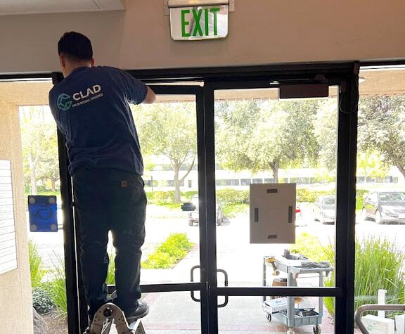 one of our pros is working on a commercial door hardware repair